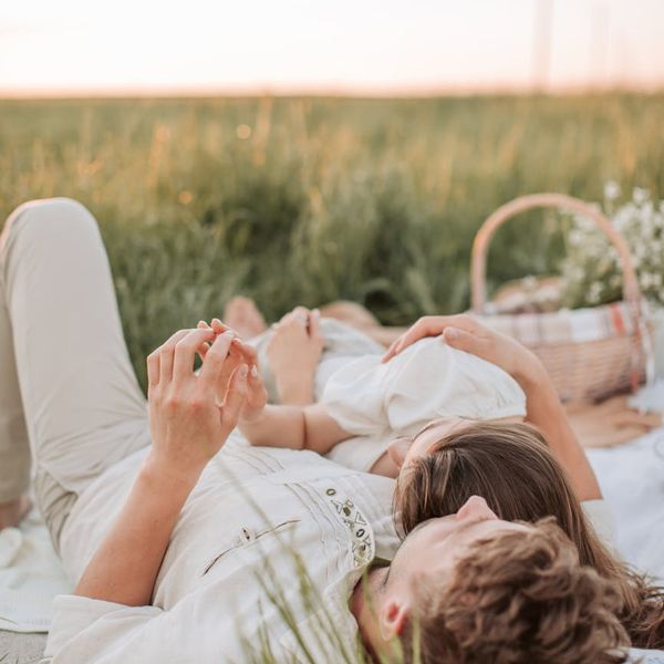Person enjoying a moment of clarity and stretching outdoors at sunset.